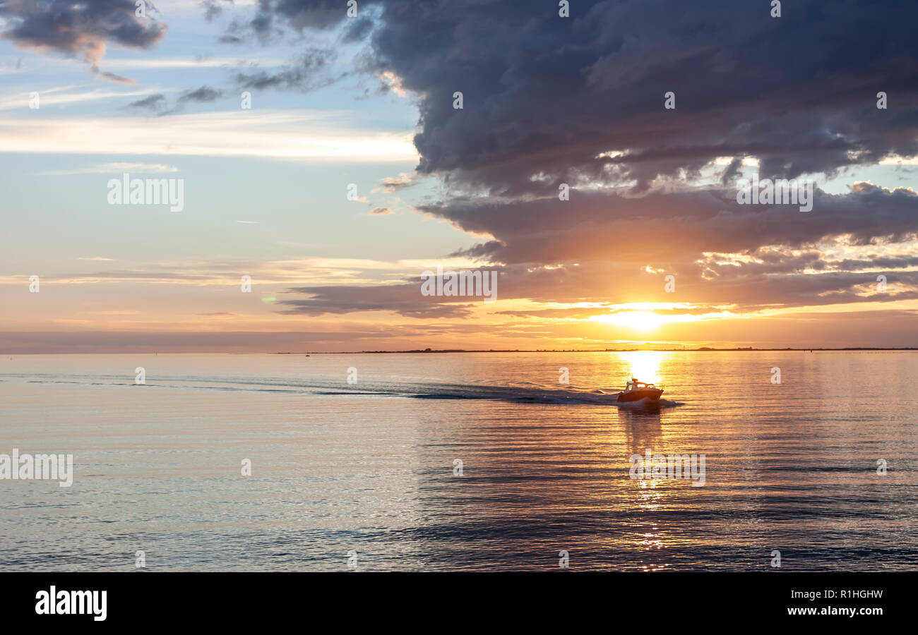 amazing sunset over the sea with dramatic clouds and boat Stock Photo ...