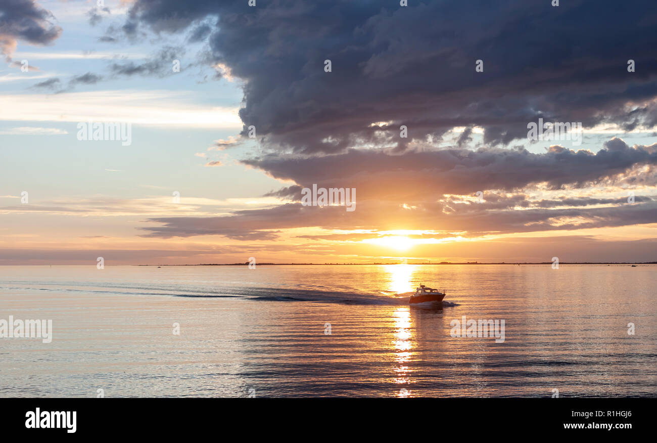amazing sunset over the sea with dramatic clouds and boat Stock Photo ...