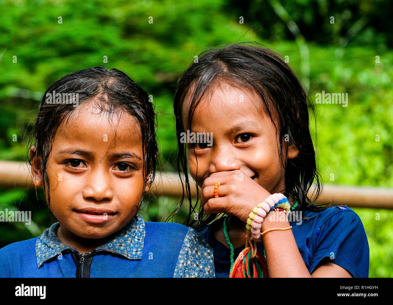 Young girls posing for the photographer. Sumba island, Nusa Tenggara, Indonesia Stock Photo