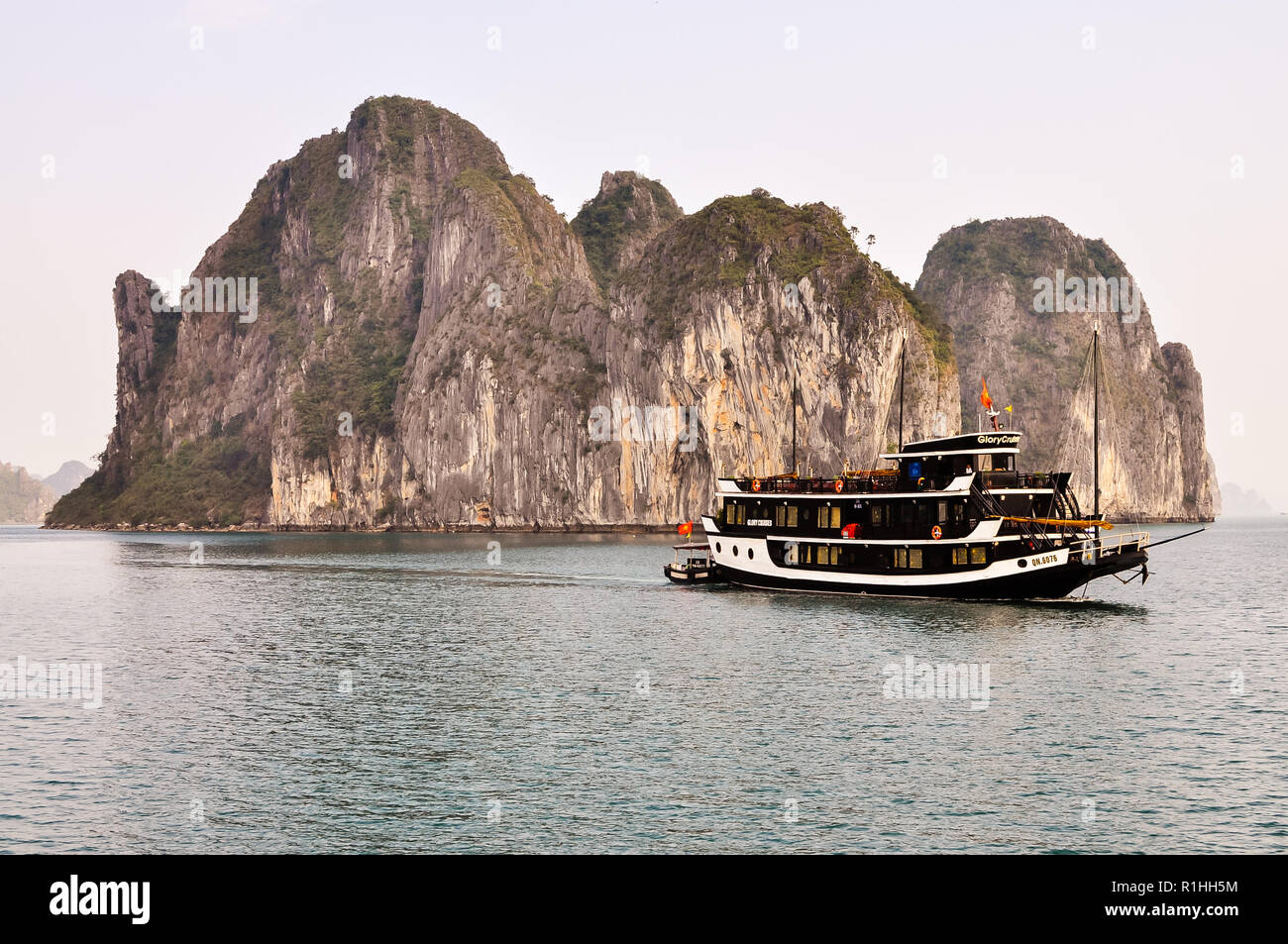 Boat and Limestone Formation in Halong Bay, Vietnam Stock Photo