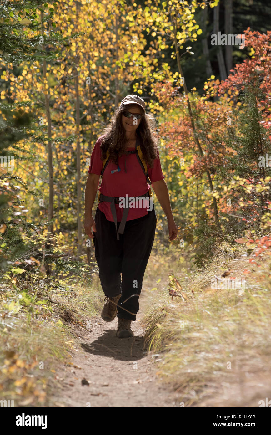 Woman hiking on a trail in the Eagle Cap Wilderness, Oregon Stock Photo