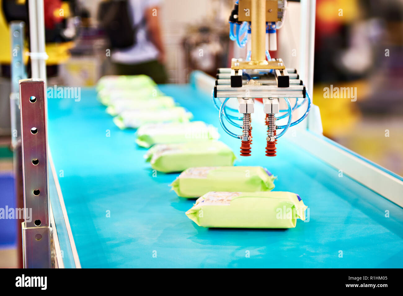 Hand robot manipulator for packaging products on conveyor Stock Photo