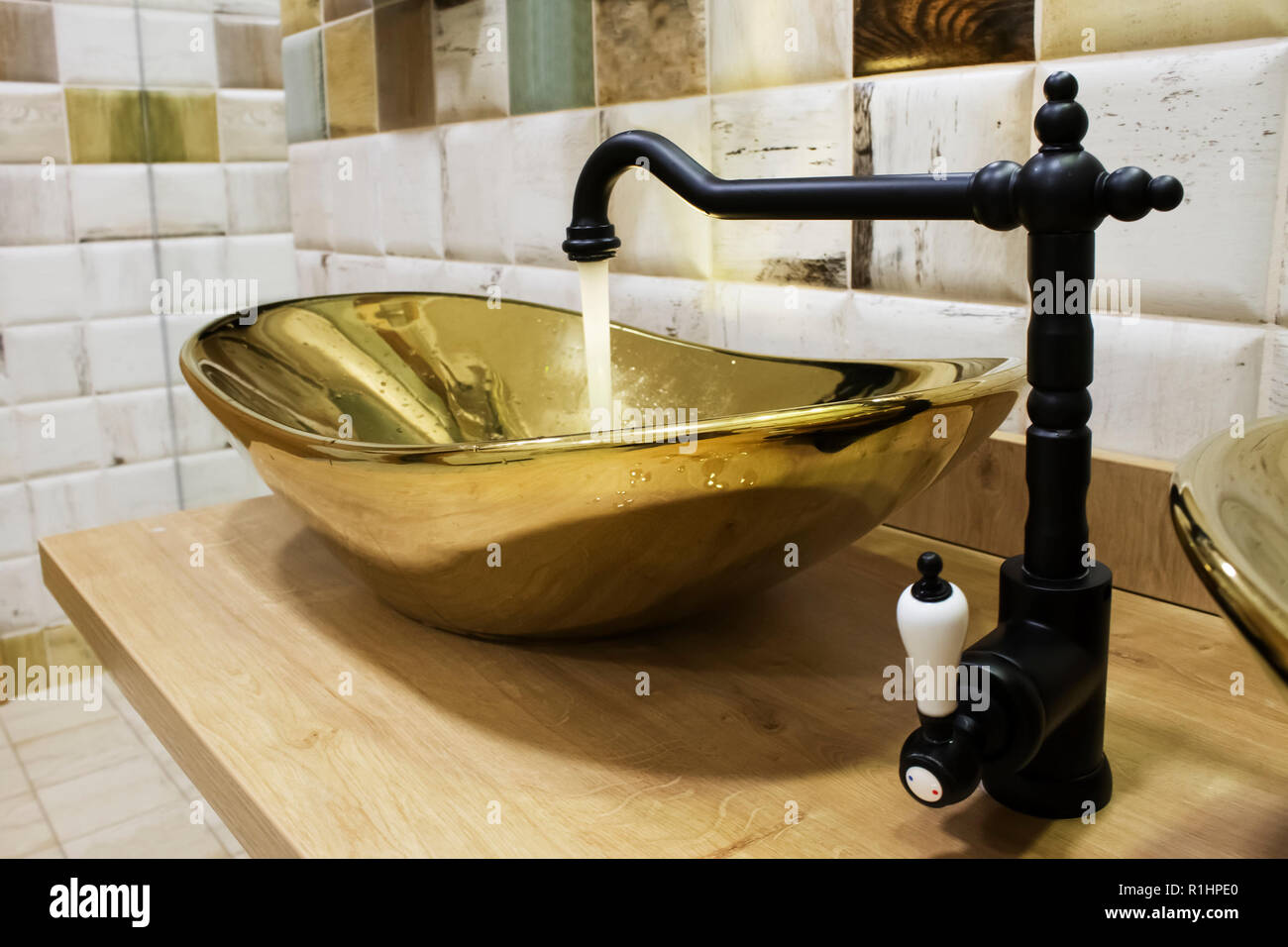 Clear Water Is Flowing From Black Faucet Into The Luxury Sink Made