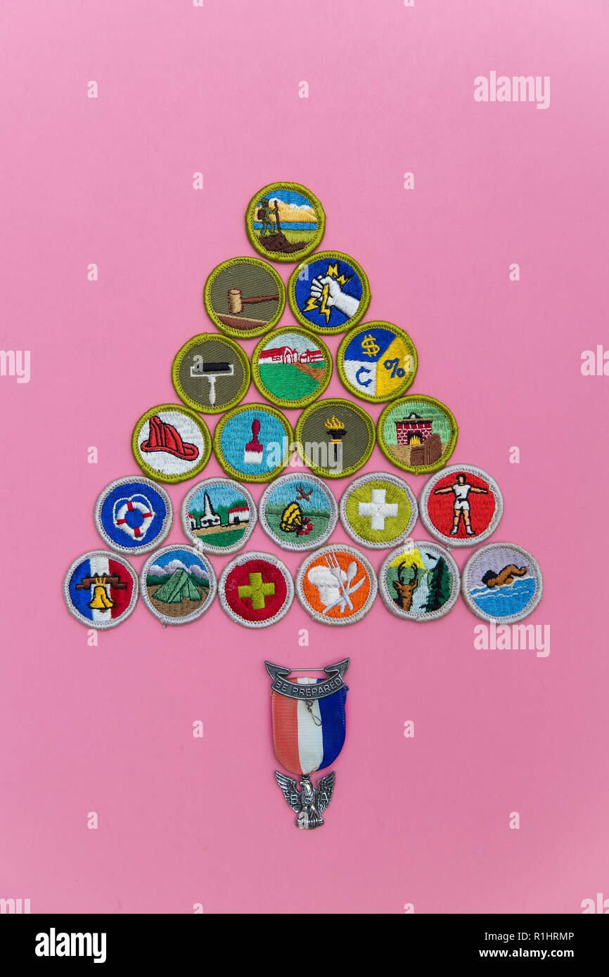 SAINT LOUIS, UNITED STATES - AUG 22, 2018:  A geometric arrangement of Boy Scouts of America (BSA) merit badges with Eagle pin on pink background as B Stock Photo