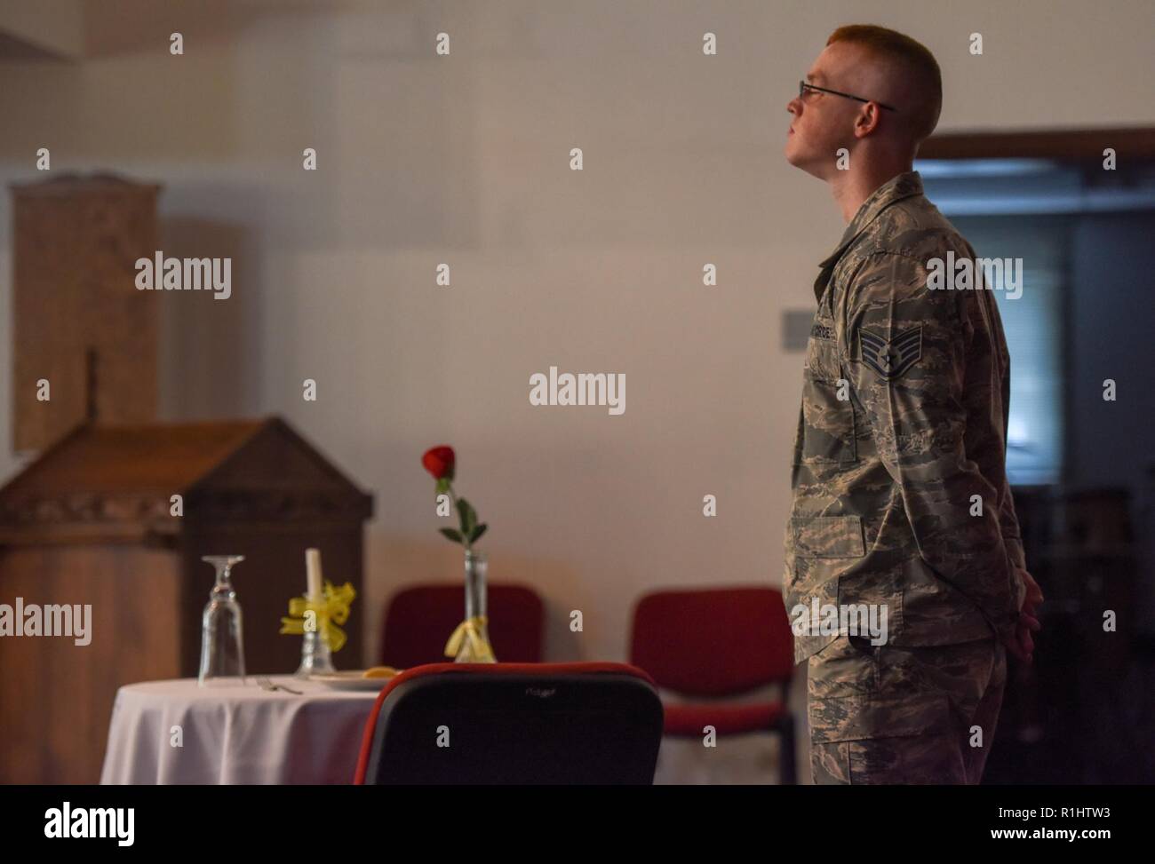 U.S. Air Force Staff Sgt. Carter Lancaster, 39th Logistics Readiness Squadron unit security manager, guards the POW/MIA table during the POW/MIA ceremony at Incirlik Air Base, Turkey, Sept. 20, 2018. The POW/MIA table is smaller than others, representing the frailty one prisoner faces alone against his or her oppressors. Stock Photo