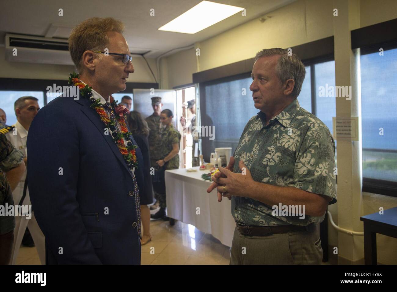 Craig Whelden (right), executive director of U.S. Marine Corps Forces, Pacific, speaks with Under Secretary of the Navy, the Honorable Thomas B. Modly, prior to a command brief at Kansas Tower, Marine Corps Base Hawaii (MCBH), Sept 21, 2018. Modly engaged with senior leaders from U.S. Marine Corps Forces, Pacific, Marine Corps Base Hawaii, and Marine Aircraft Group 24 to gain a better understanding of the aviation units and readiness of Marine assets aboard Oahu. Stock Photo