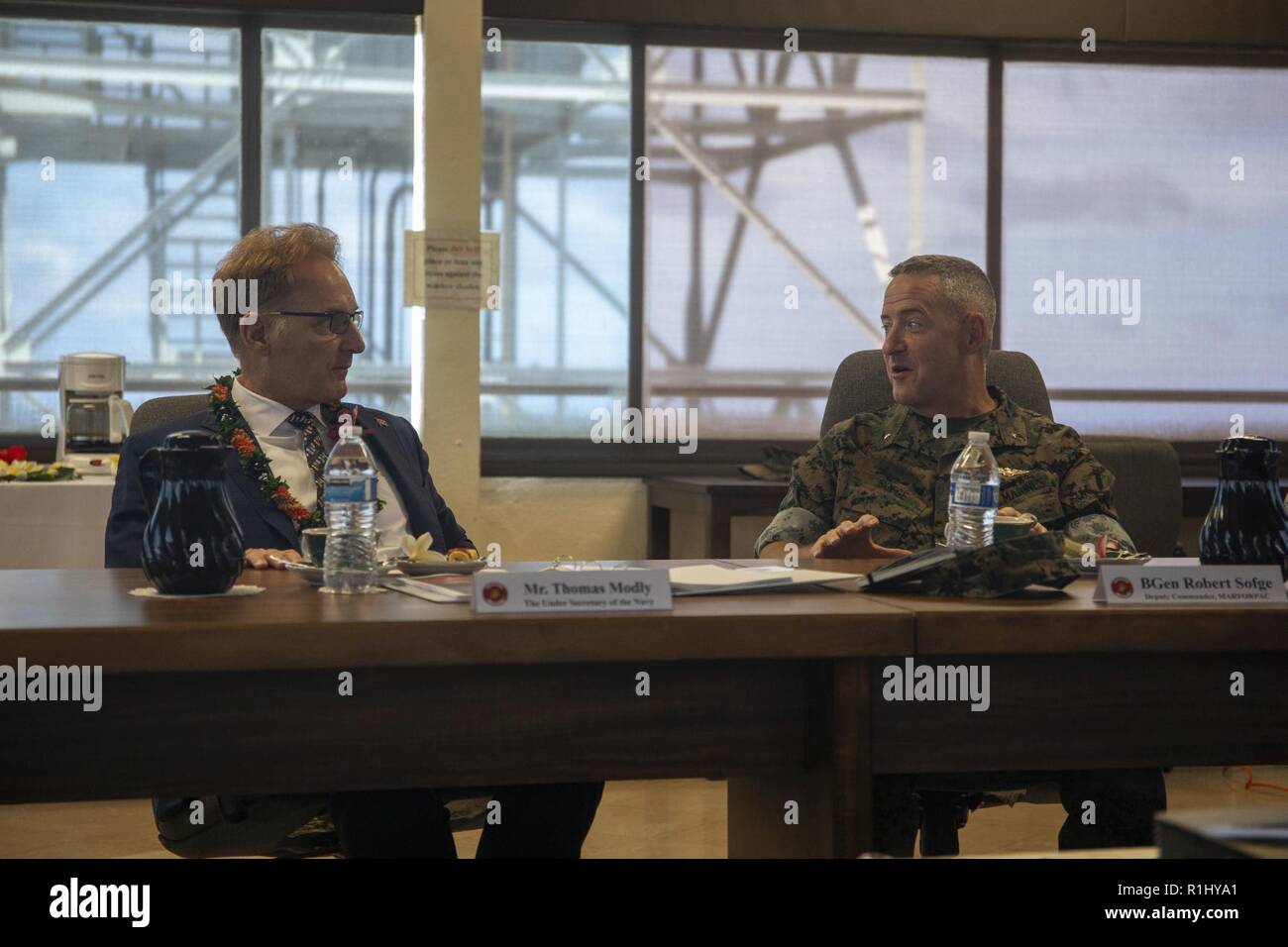 U.S. Marine Corps Brig. Gen. Robert Sofge, deputy commander, U.S. Marine Corps Forces, Pacific, speaks with Under Secretary of the Navy, the Honorable Thomas B. Modly, during a command brief at Kansas Tower, Marine Corps Base Hawaii (MCBH), Sept. 21, 2018. Modly engaged with senior leaders from U.S. Marine Corps Forces, Pacific, Marine Corps Base Hawaii, and Marine Aircraft Group 24 to gain a better understanding of the aviation units and readiness of Marine assets aboard Oahu. Stock Photo