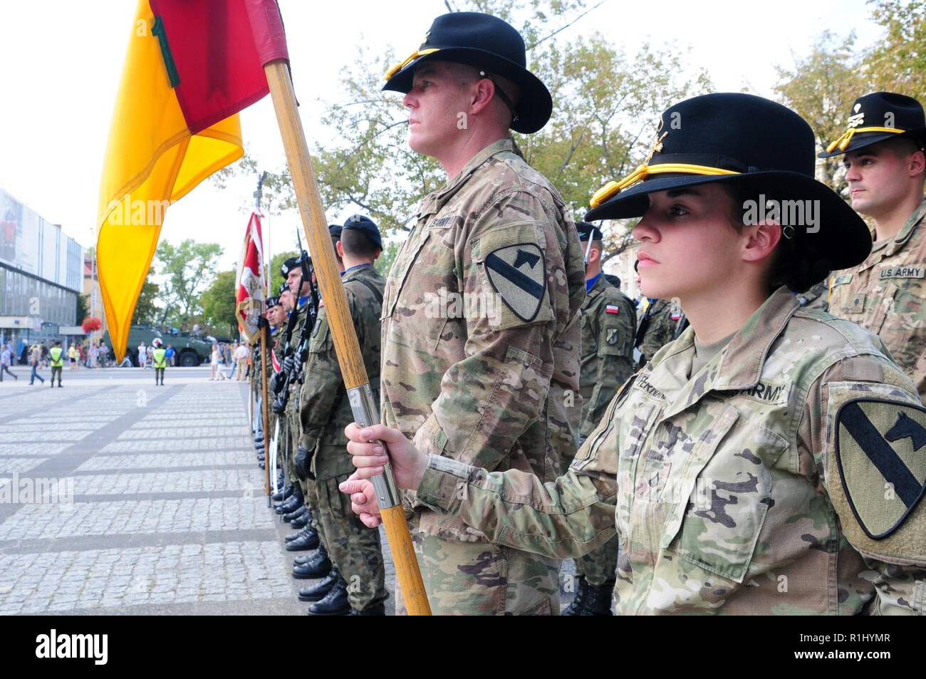 Soldiers assigned to Headquarters and Headquarters Company, 1st Armored Brigade Combat Team, 1st Cavalry Division, stand in formation alongside 11th 'Lubuska' Armoured Cavalry Division soldiers during a ceremony to observe the Black Division Day in Zielona Gora, Poland, Sept. 21, 2018. The 11th 'Lubuska' ACD, also known as The Black Division, honors this military holiday as a commemoration of the battle of Vienna when its commander, King John III Sobieski, led forces to defeat the Turkish army of the Ottoman Empire in September 1683. Stock Photo