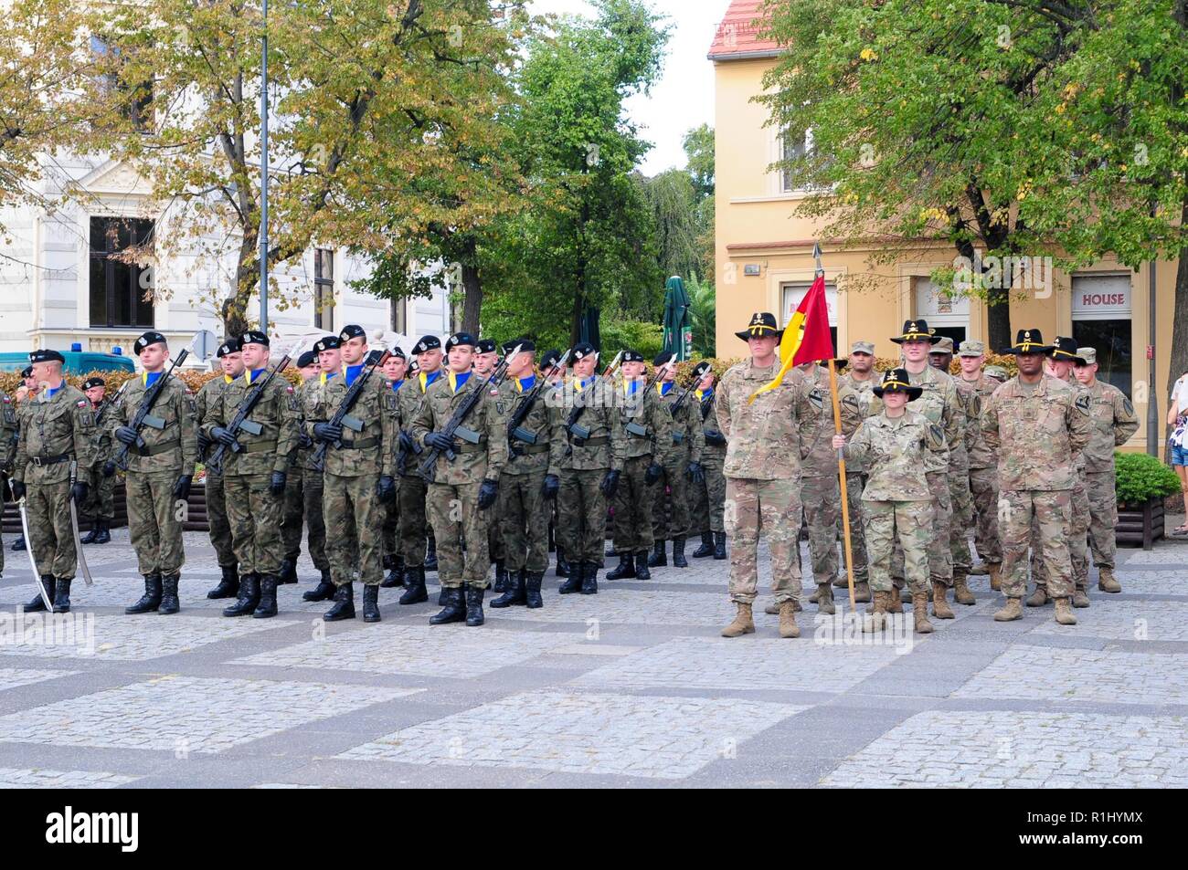 Soldiers assigned to Headquarters and Headquarters Company, 1st Armored Brigade Combat Team, 1st Cavalry Division, stand in formation alongside the Polish 11th 'Lubuska' Armoured Cavalry Division soldiers during a ceremony to observe the Black Division Day in Zielona Gora, Poland, Sept. 21, 2018. The 11th Lubuska ACD, also known as The Black Division, honors this military holiday as a commemoration of the battle of Vienna when its commander, King John III Sobieski, led forces to defeat the Turkish army of the Ottoman Empire in September 1683. Stock Photo