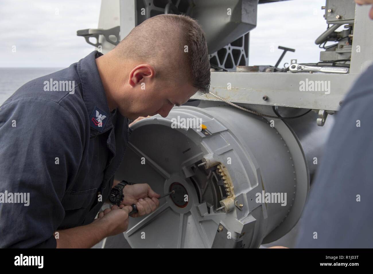 PACIFIC OCEAN (Sept. 23, 2018) Fire Controlman 2nd Class Benjamin Pruitt, from Dawsonville, Ga., removes a drum casing while performing maintenance on the aft close-in weapons system (CIWS) aboard the amphibious assault ship USS Bonhomme Richard (LHD 6). Bonhomme Richard is operating in the 3rd Fleet area of operations. Stock Photo