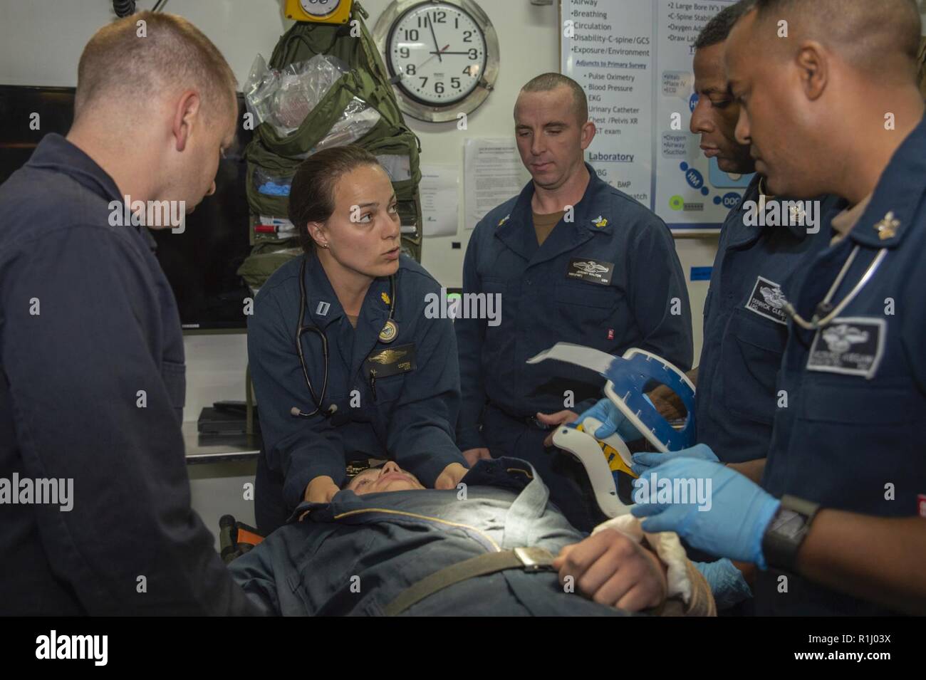 PACIFIC OCEAN (Sept. 21, 2018) Lt. Katherine Cortez, from Broken Arrow, Okla., discussess triage procedures with Sailors during a mass casualty drill in the medical triage room of the amphibious assault ship USS Bonhomme Richard (LHD 6). Bonhomme Richard is currently underway in the U.S. 3rd Fleet area of operations. Stock Photo