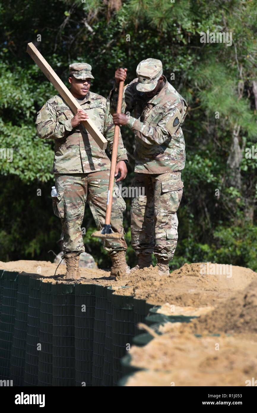 Mixed units of South Carolina National Guard Engineers and Transportation Corps are working round the clock to build flood water abatement barriers to protect the raw water pumping plant in Pawleys Island, S.C., Sept. 24, 2018. The purpose of this project is to protect the fresh water supply for surrounding areas as extensive flooding is anticipated from the aftermath of Hurricane Florence last week. The South Carolina National Guard has over 2,100 Soldiers and Airmen on duty, including support from the Pennsylvania, Tennessee, New York, Alaska, Maryland, Georgia, Virginia and Mississippi Nati Stock Photo