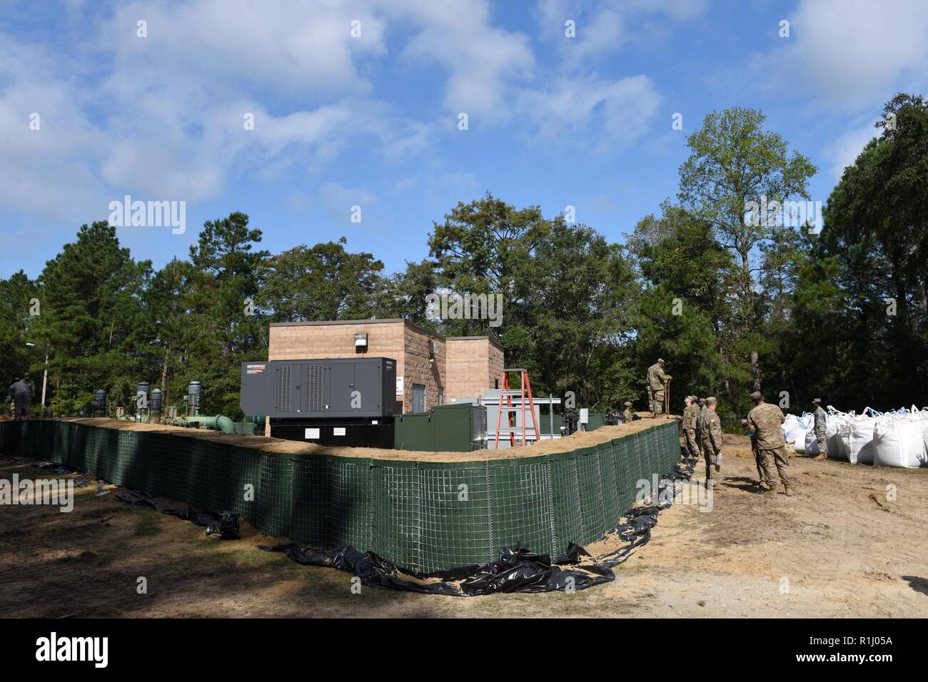 Mixed units of South Carolina National Guard Engineers and Transportation Corps are working round the clock to build flood water abatement barriers to protect the raw water pumping plant in Pawleys Island, S.C., Sept. 24, 2018. The purpose of this project is to protect the fresh water supply for surrounding areas as extensive flooding is anticipated from the aftermath of Hurricane Florence last week. The South Carolina National Guard has over 2,100 Soldiers and Airmen on duty, including support from the Pennsylvania, Tennessee, New York, Alaska, Maryland, Georgia, Virginia and Mississippi Nati Stock Photo