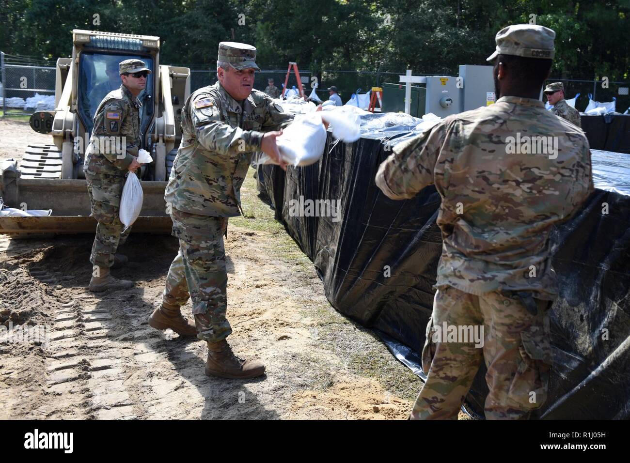 Mixed units of South Carolina National Guard Engineers and Transportation Corps are working round the clock to build flood water abatement barriers to protect the raw water pumping plant in Pawleys Island, S.C., Sept. 24, 2018. Brig. Gen. Jeff Jones, the SCNG Assistant Adjutant General for Army arrives to show his appreciation for the hard work being done by SCNG Soldiers and to assist with the construction project. The purpose of this project is to protect the fresh water supply for surrounding areas as extensive flooding is anticipated from the aftermath of Hurricane Florence last week. The  Stock Photo
