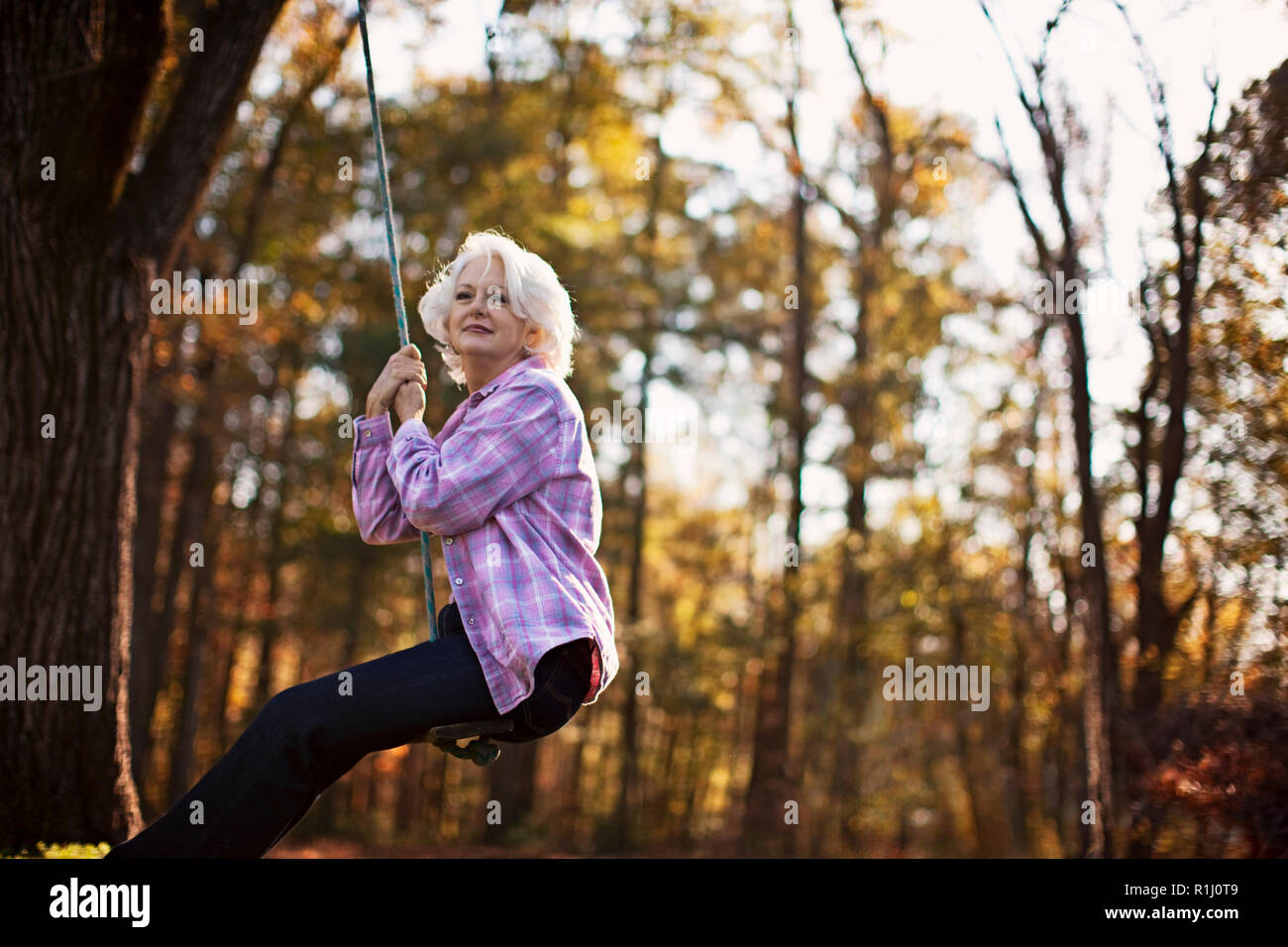 Mature woman on swing 1 horizontal hi-res stock photography and images ...