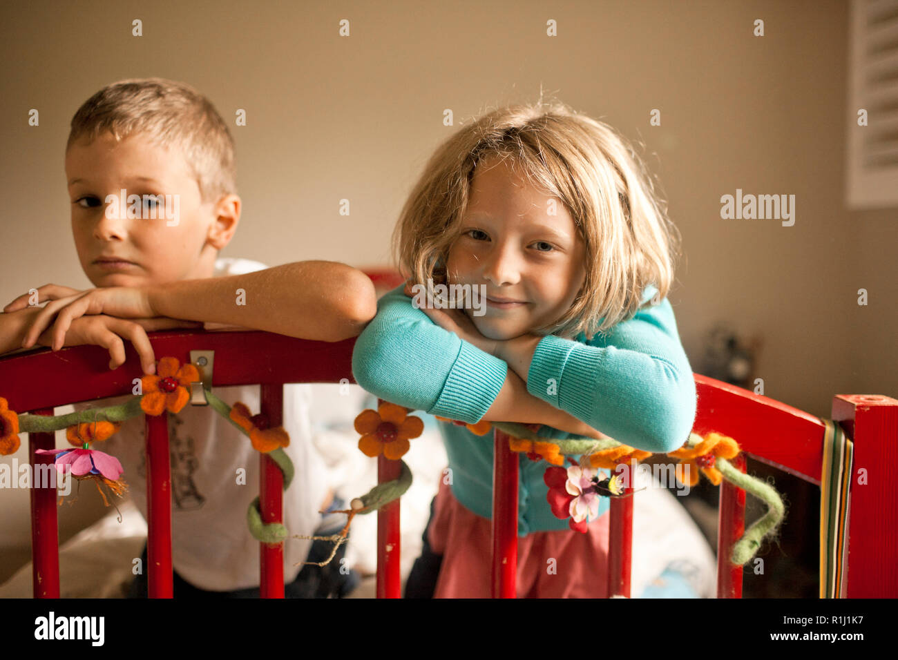 Portrait of brother and sister in their bedroom. Stock Photo