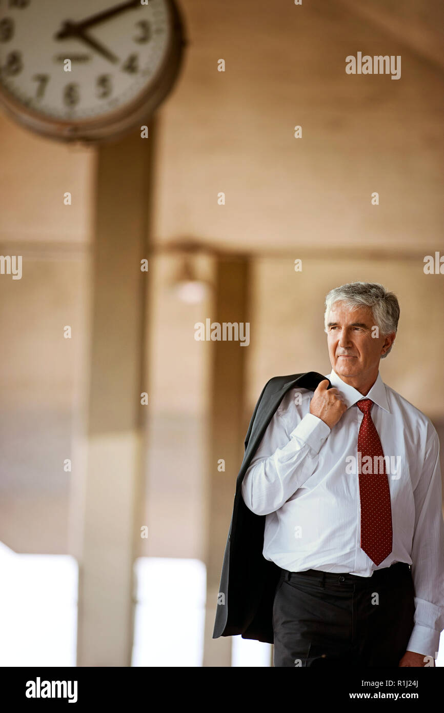 Senior businessman waiting in train station. Stock Photo