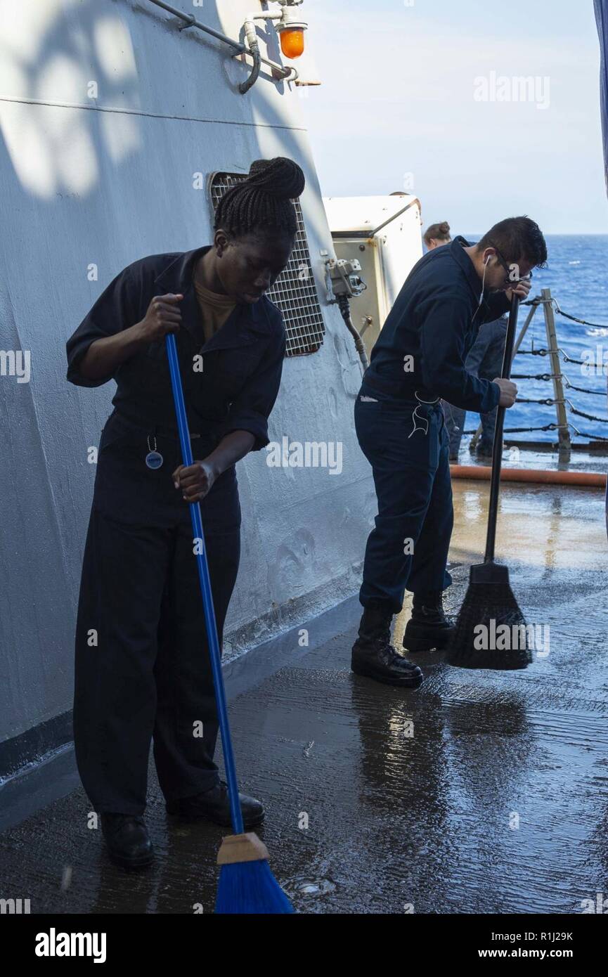 ATLANTIC OCEAN (Sept. 19, 2018) Sailors clean the weather decks during a fresh-water wash-down aboard the Arleigh Burke-class guided-missile destroyer USS Arleigh Burke (DDG-51) in the Atlantic Ocean Sept. 19, 2018. Arleigh Burke, homeported at Naval Station Norfolk, is conducting naval operations in the U.S. 6th Fleet area of operations in support of U.S. national security interests in Europe and Africa. Stock Photo