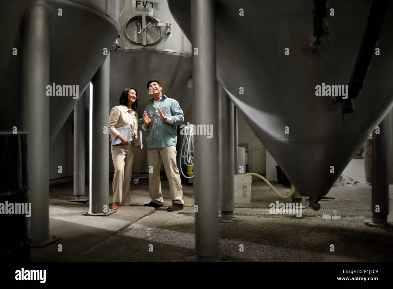 Two colleagues discussing work in a warehouse. Stock Photo