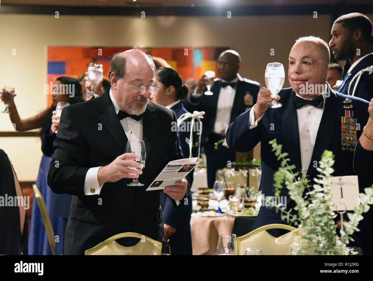 Bill Keesler, relative of 2nd Lt. Samuel Keesler, and U.S. Air Force Senior Master Sgt. Israel Del Toro, 98th Flying Training Squadron accelerated freefall training program superintendent, U.S. Air Force Academy, Colorado, hold their glasses up for a toast during the U.S Air Force 71st Birthday Ball at the Imperial Palace Casino, Biloxi, Mississippi, Sept. 22, 2018. The event, hosted by the 81st Training Wing and the John C. Stennis Chapter Air Force Association, also included a cake cutting ceremony. Stock Photo