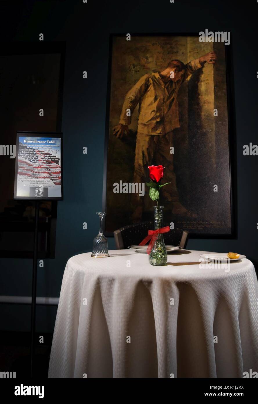 The remembrance table stands on display in tribute to those who were prisoners of war or missing in action inside the Satellite Dish dining facility at Schriever Air Force Base, Colorado, Sept. 21, 2018. Each component of the display represents different aspects. For example, the table’s small size symbolizes the frailty of one prisoner alone against his oppressors and the white table cloth represents purity of their response to our country’s call to arms. Stock Photo