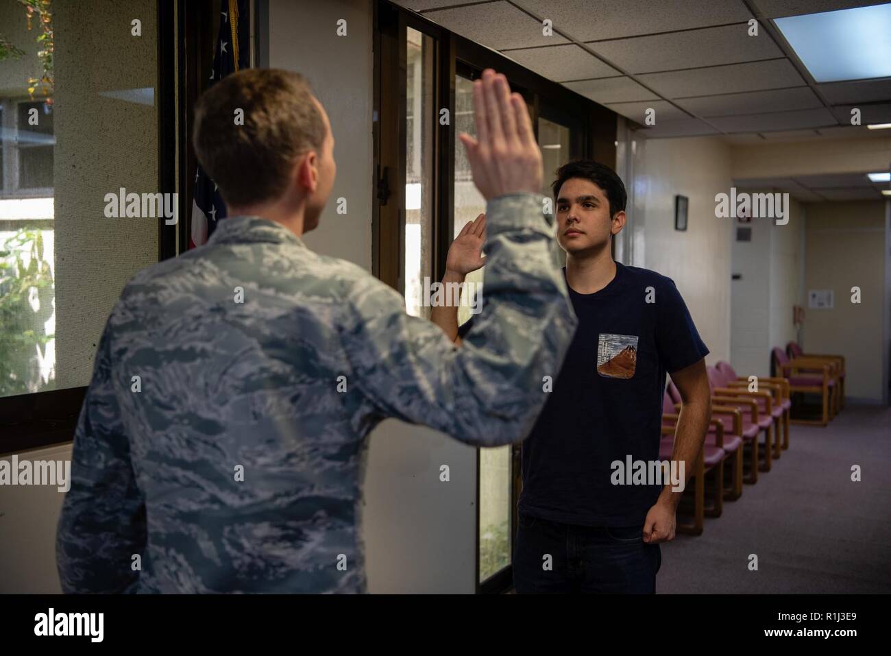 U.S. Air Force Maj. Chris Dufford, 18th Aerospace Medical Squadron bioenvironmental engineering chief of operations, swears Dean Taylor into the Air Force delayed entry program.  swearing in to the delayed entry program. The Air Force recruits the best candidates possible, and then provides them with tough, highly technical training that gives them the right skills to replenish the combat capability of America's Air Force. Stock Photo