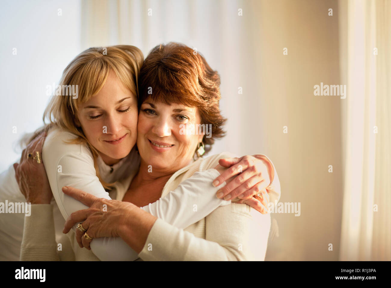Hugged Woman being hugged hi-res stock photography and images - Alamy