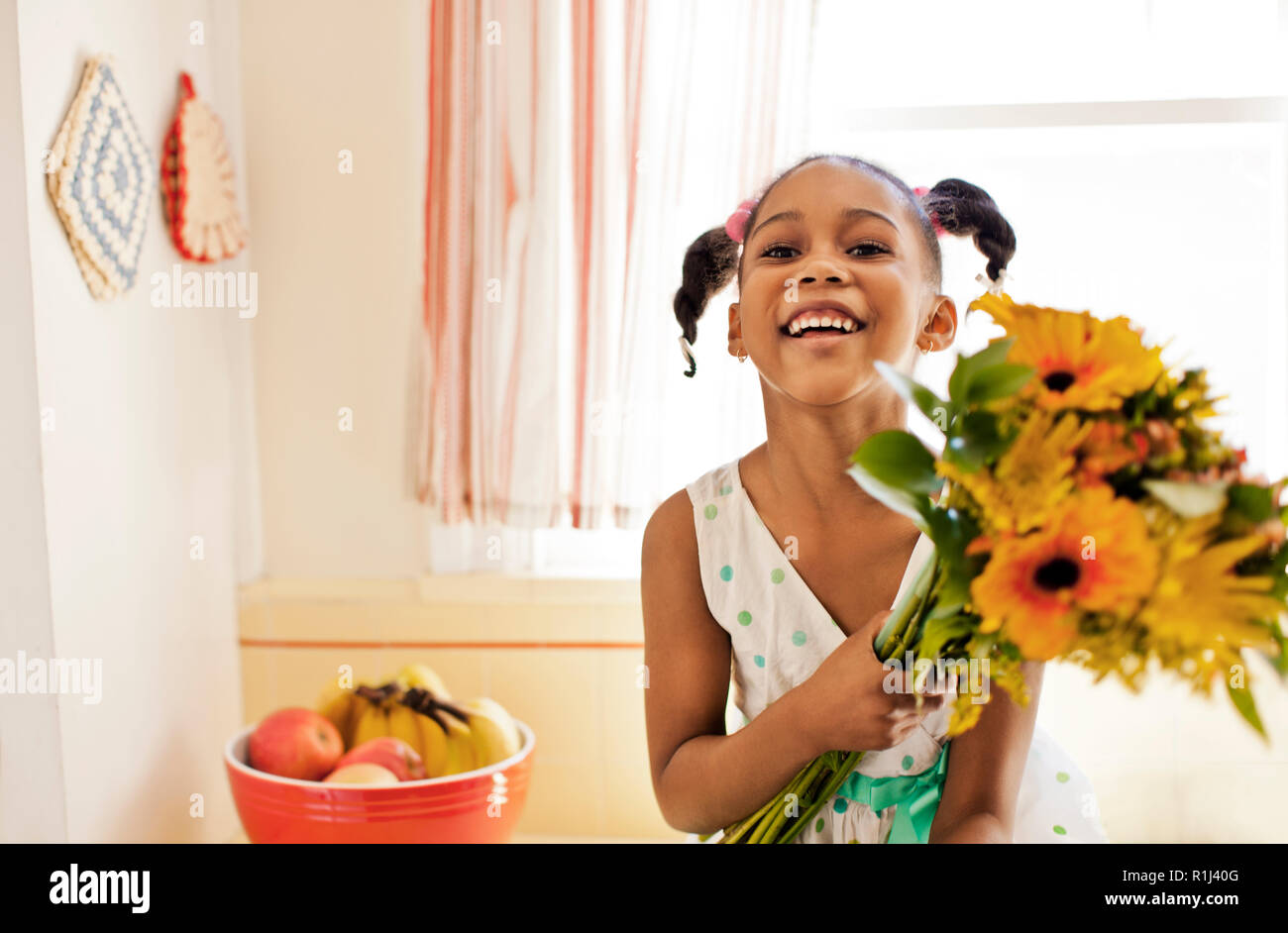 Portrait of a happy young girl holding a bunch of flowers Stock Photo ...