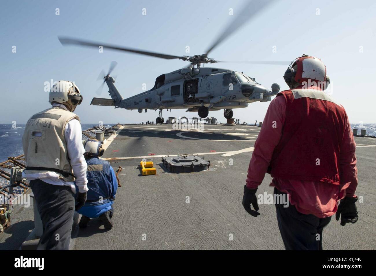 MEDITERRANEAN SEA (Sept. 26, 2018) An MH-60R Sea Hawk, assigned to the “Vipers” of Helicopter Maritime Strike Squadron (HSM) 48, lands aboard the Arleigh Burke-class guided-missile destroyer USS Arleigh Burke (DDG 51) in the Mediterranean Sea Sept. 26, 2018. Arleigh Burke, homeported at Naval Station Norfolk, is conducting naval operations in the U.S. 6th Fleet area of operations in support of U.S. national security interests in Europe and Africa. Stock Photo