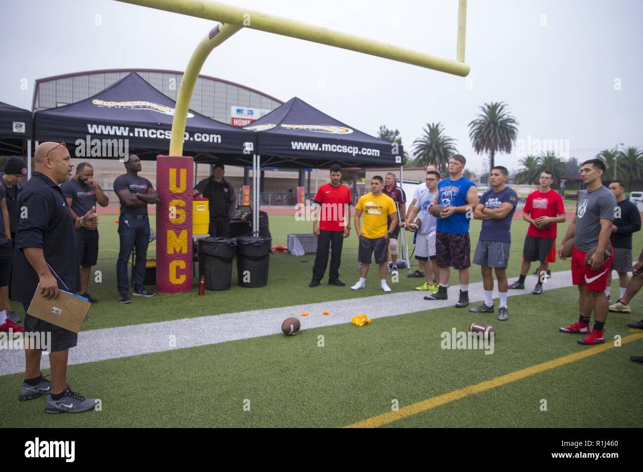 Mr. Eddie Bolanos, athletic director, Semper Fit, Marine Corps Community Services, briefs U.S. Marines on rules for the Commanding General’s Cup (CG’s Cup) Punt, Pass, & Kick competition at Paige Field House at Marine Corps Base (MCB) Camp Pendleton, California, Sept. 26, 2018. The CG’s Cup is an intramural sports program that was developed to give service members from various units across MCB Camp Pendleton an opportunity to compete in organized sporting events in order to promote combat readiness, teamwork and esprit de corps. The CG’s cup also allows service members to earn points for their Stock Photo