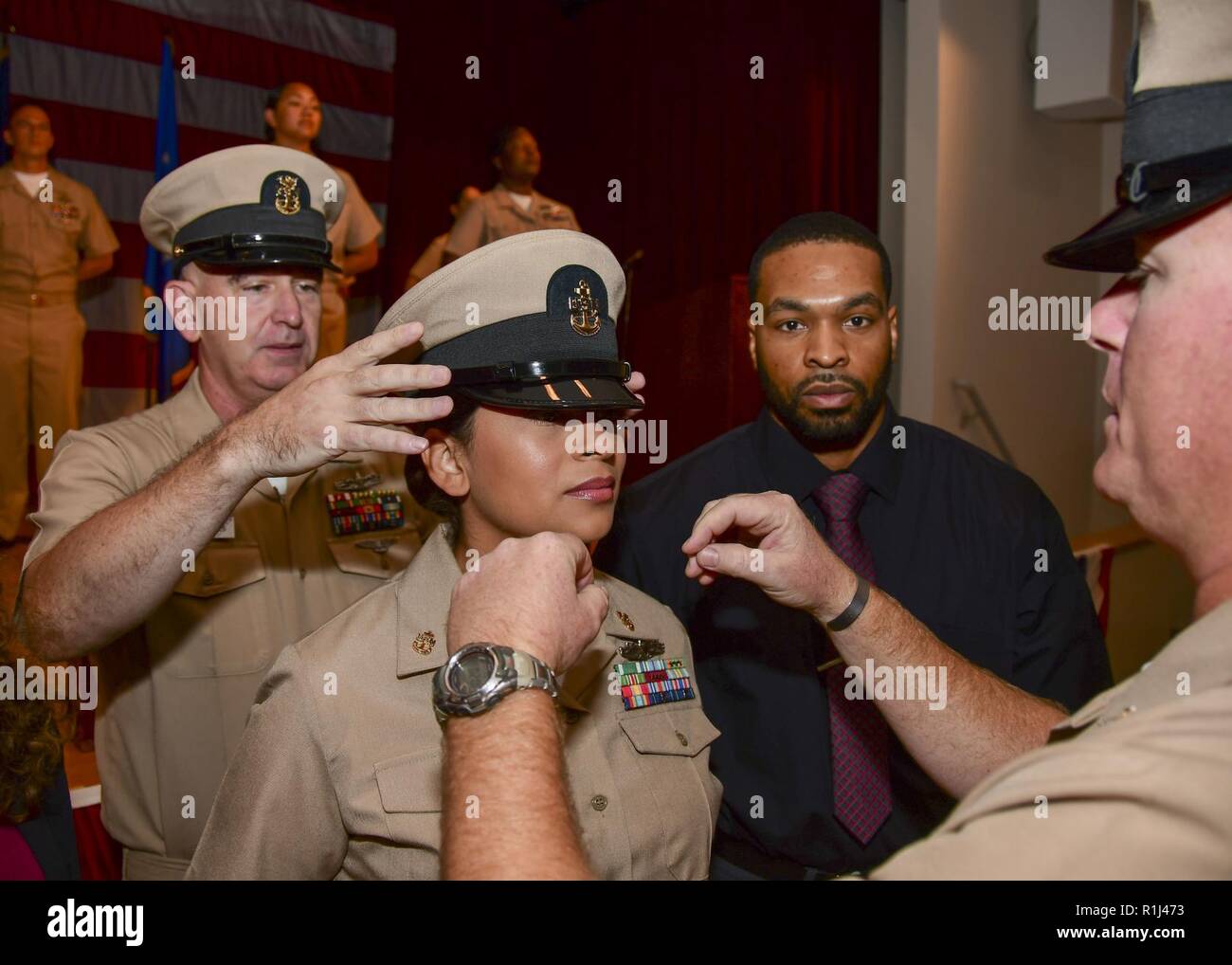 PORTSMOUTH, Va. (Sept. 21, 2018) –  Master Chief Hospital Corpsman John Mooers dons the cover on newly pinned Chief Hospital Corpsman Tamesha McKinnon during the Naval Medical Center Portsmouth (NMCP) fiscal year 2019 chief petty officer (CPO) pinning ceremony in the auditorium on Sept. 21. Ten chief petty officers from NMCP and its branch clinics were pinned during the ceremony. Stock Photo