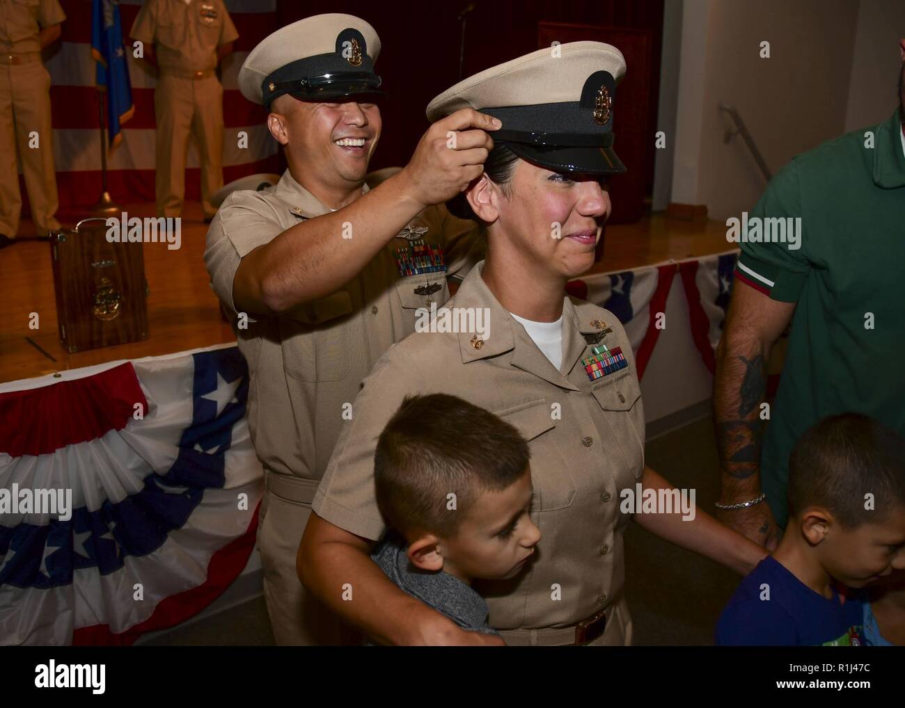 PORTSMOUTH, Va. (Sept. 21, 2018) –  Hospital Corpsman Sonny Ocampo dons the cover on newly pinned Chief Hospital Corpsman Andiria Gerovac during the Naval Medical Center Portsmouth (NMCP) fiscal year 2019 chief petty officer (CPO) pinning ceremony in the auditorium on Sept. 21. Ten chief petty officers from NMCP and its branch clinics were pinned during the ceremony. Stock Photo