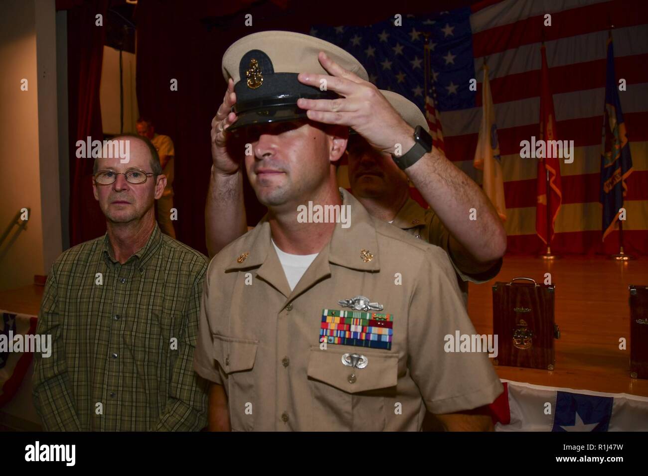 PORTSMOUTH, Va. (Sept. 21, 2018) –  Chief Navy Counselor Michael Tate dons the cover on newly pinned Chief Hospital Corpsman Brandon Glassco during the Naval Medical Center Portsmouth (NMCP) fiscal year 2019 chief petty officer (CPO) pinning ceremony in the auditorium on Sept. 21. Ten chief petty officers from NMCP and its branch clinics were pinned during the ceremony. Stock Photo