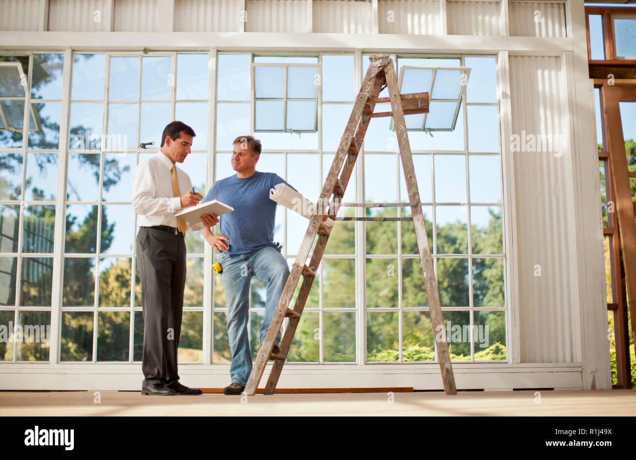 Two businessmen looking at samples on a construction site. Stock Photo