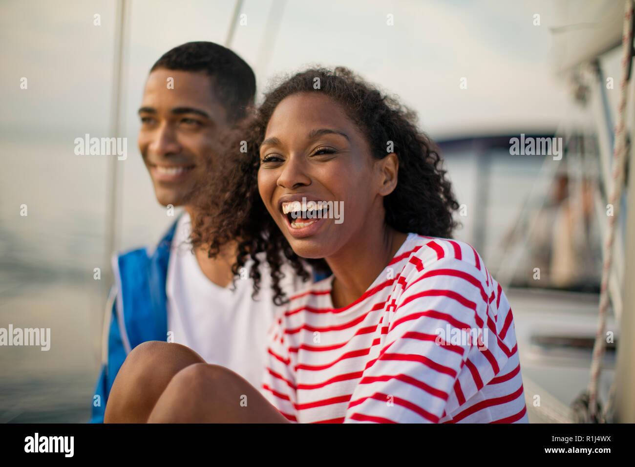 Young couple relaxing and having fun while sailing. Stock Photo