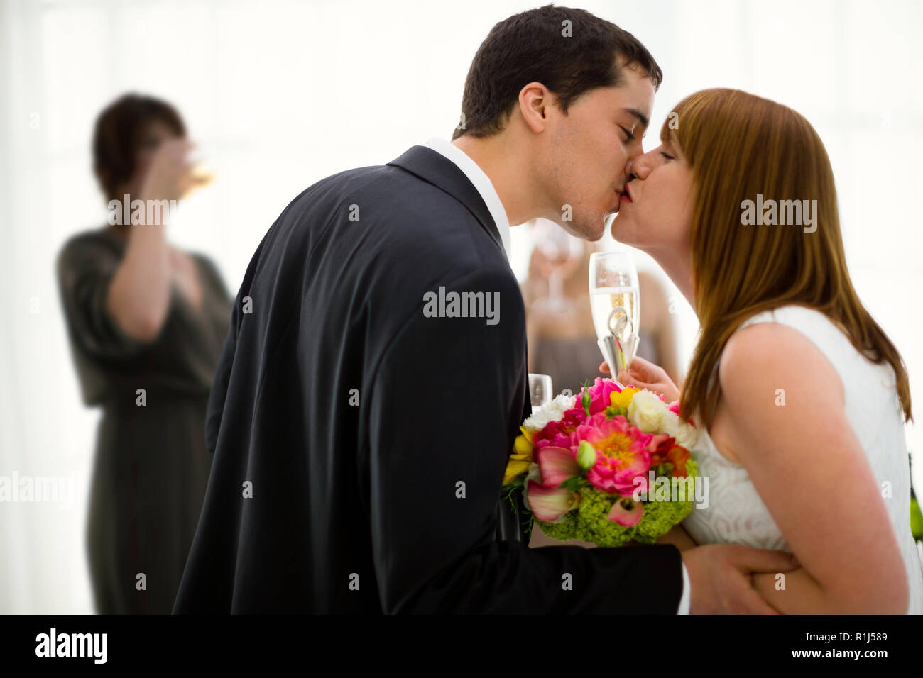 Bride and groom kissing at wedding reception. Stock Photo