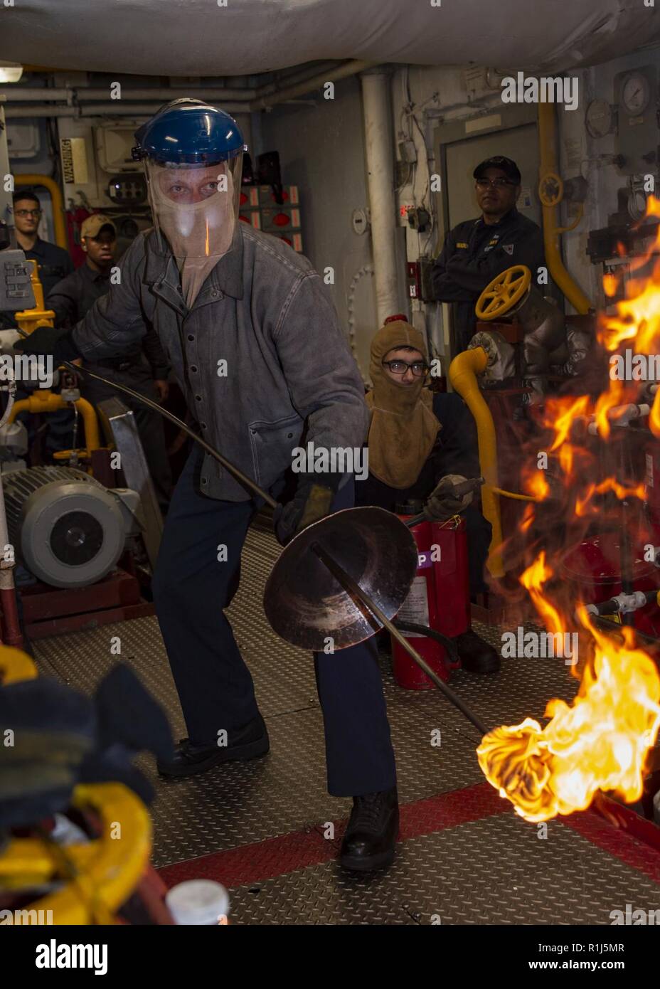 SAN FRANCISCO (Oct. 4, 2018) Capt. Gregory Thoroman, executive officer of the amphibious assault ship USS Bonhomme Richard (LHD 6), prepares to ignite the No.1 boiler in the aft main machinery room during San Francisco Fleet Week 2018. San Francisco Fleet Week is an opportunity for the American public to meet their Navy, Marine Corps and Coast Guard teams and experience America’s sea services. During fleet week, service members participate in various community service events, showcase capabilities and equipment to the community, and enjoy the hospitality of San Francisco and its surrounding ar Stock Photo