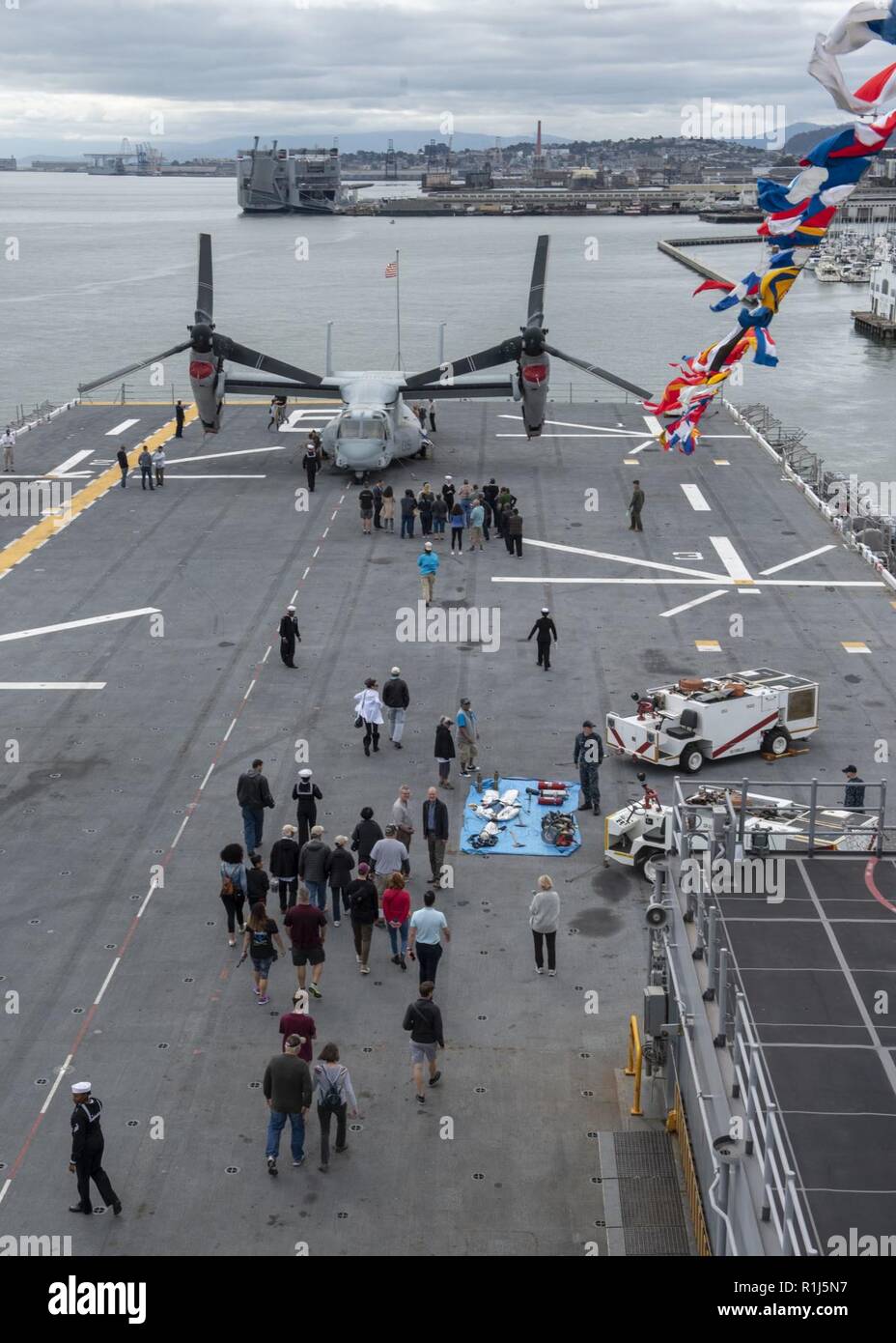 SAN FRANCISCO (Oct. 4, 2018) Visitors tour the flight deck of the amphibious assault ship USS Bonhomme Richard (LHD 6) during a general public ship tour as part of San Francisco Fleet Week 2018. San Francisco Fleet Week is an opportunity for the American public to meet their Navy, Marine Corps and Coast Guard teams and experience America’s sea services. During fleet week, service members participate in various community service events, showcase capabilities and equipment to the community, and enjoy the hospitality of San Francisco and its surrounding areas. Stock Photo