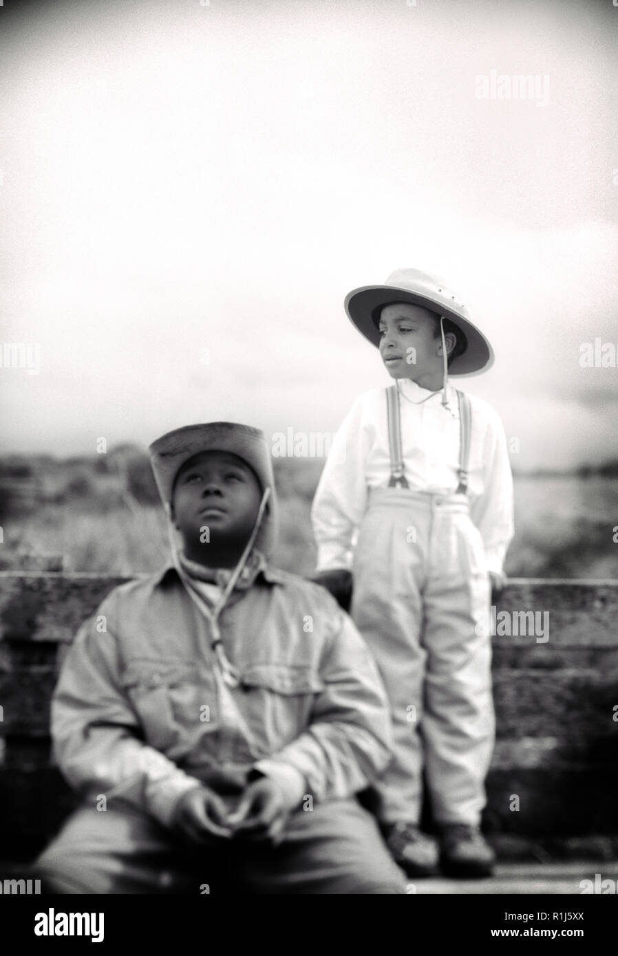 Front view of two kids wearing hats. Stock Photo