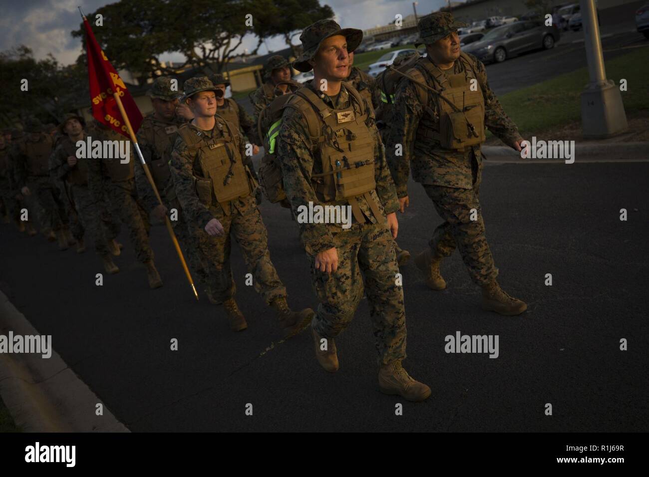 U.S. Marines assigned to Headquarters Battalion, Marine Corps Base Hawaii (MCBH), conduct a battalion hike, MCBH, Oct. 5, 2018. The purpose of the hike was to increase physical and mental stamina, build espirit de corps, and to bolster combat readiness. Stock Photo