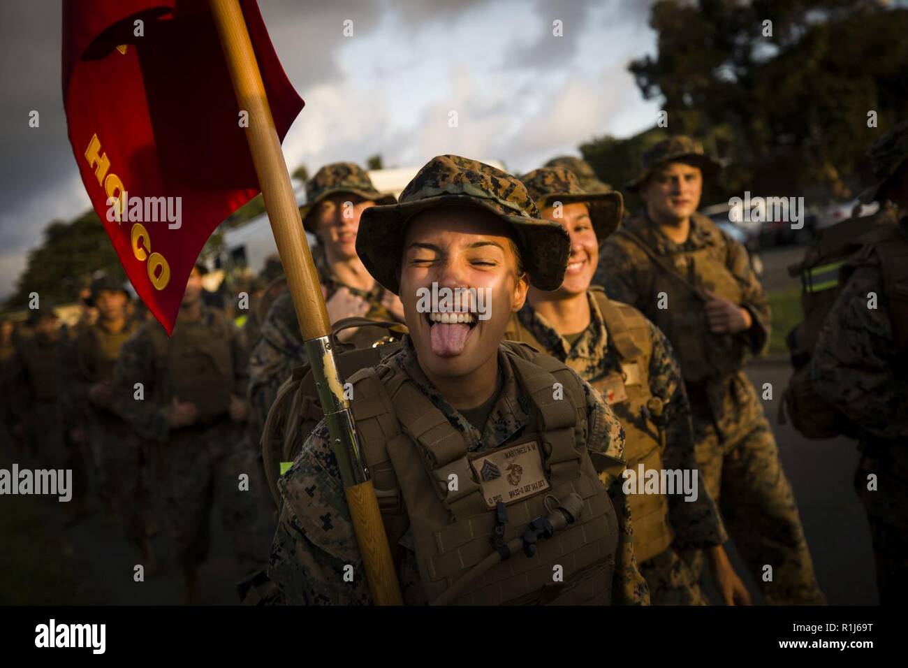 U.S. Marines Corps Sgt. Alexandria M. Aglio, a career planner, Headquarters Battalion, Marine Corps Base Hawaii (MCBH), displays enthusiasm during the battalion hike, MCBH, Oct. 5, 2018. The purpose of the hike was to increase physical and mental stamina, build espirit de corps, and to bolster combat readiness. Stock Photo
