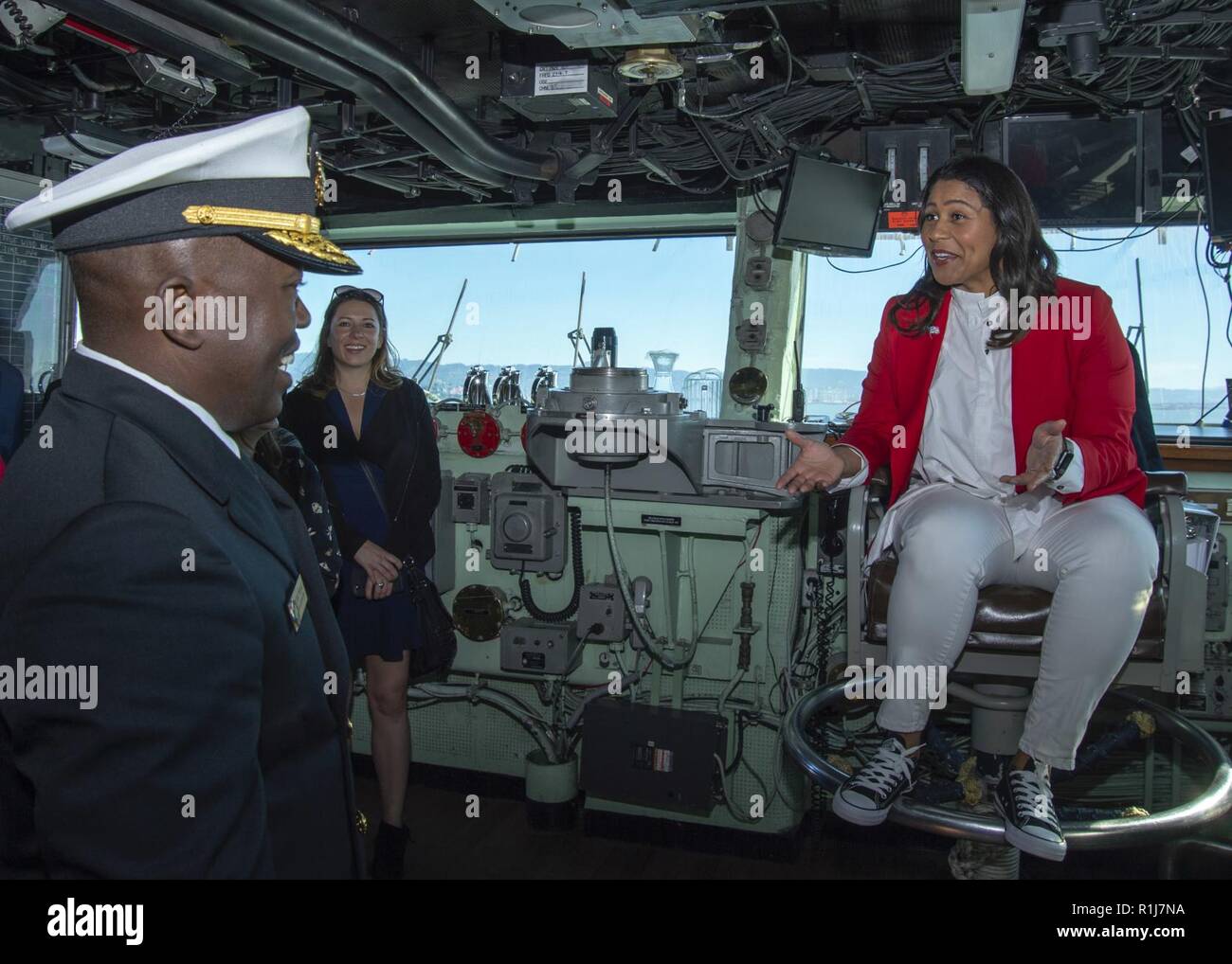 SAN FRANCISCO (Oct. 7, 2018) London Breed, right, mayor of San Francisco, speaks with Rear Adm. Cedric Pringle, commander, Expeditionary Strike Group (ESG) 3, during a tour of the amphibious assault ship USS Bonhomme Richard (LHD 6) as part of San Francisco Fleet Week 2018. San Francisco Fleet Week is an opportunity for the American public to meet their Navy, Marine Corps and Coast Guard teams and experience America’s sea services. During fleet week, service members participate in various community service events, showcase capabilities and equipment to the community, and enjoy the hospitality  Stock Photo