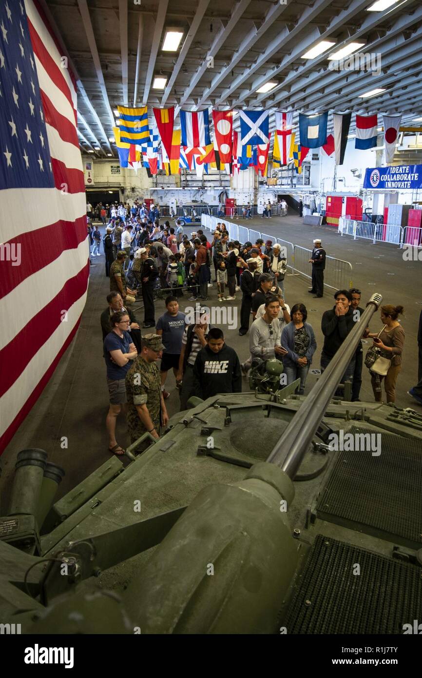 SAN FRANCISCO (Oct. 7, 2018) Visitors gather for presentation of a Marine light armored vehicle (LAV-25) during a general public tour of the amphibious assault ship USS Bonhomme Richard (LHD 6) during San Francisco Fleet Week 2018. San Francisco Fleet Week is an opportunity for the American public to meet their Navy, Marine Corps, and Coast Guard teams and experience America’s sea services. During Fleet Week, service members participate in various community service events, showcase capabilities and equipment to the community, and enjoy the hospitality of San Francisco and its surrounding areas Stock Photo