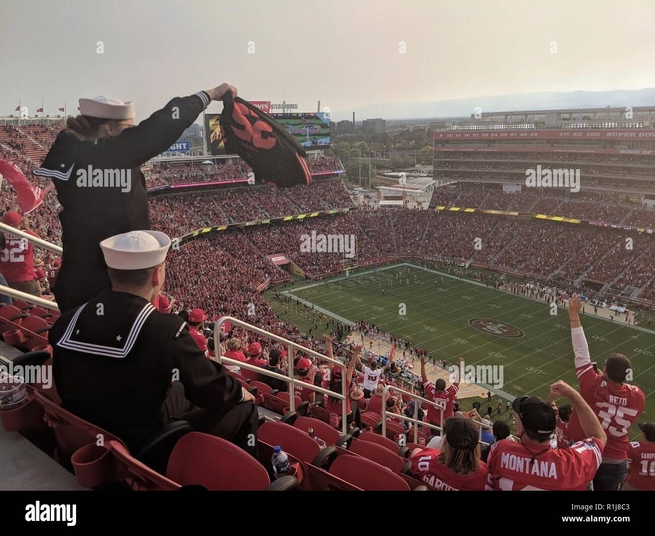 SANTA CLARA, Calif. (Oct. 7, 2018) Aviation Boatswain’s Mate (Handling) 3rd Class Shelby Williams, from Wakefield, Kan., left, and Fireman Jaden Buter, from San Antonio, both assigned to the amphibious assault ship USS Bonhomme Richard (LHD 6), celebrate a touchdown at the San Francisco 49ers-Arizona Cardinals football game as part of a Morale, Welfare, and Recreation trip during San Francisco Fleet Week 2018. San Francisco Fleet Week is an opportunity for the American public to meet their Navy, Marine Corps and Coast Guard teams and experience America’s sea services. During fleet week, servic Stock Photo
