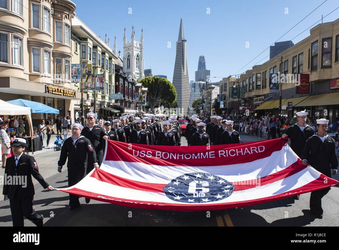 SAN FRANCISCO (Oct. 7, 2018) Sailors, assigned to the amphibious assault ship USS Bonhomme Richard (LHD 6), march in formation during the Italian Heritage Parade in support of San Francisco Fleet Week 2018. San Francisco Fleet Week is an opportunity for the American public to meet their Navy, Marine Corps and Coast Guard teams and experience America’s sea services. During fleet week, service members participate in various community service events, showcase capabilities and equipment to the community, and enjoy the hospitality of San Francisco and its surrounding areas. Stock Photo