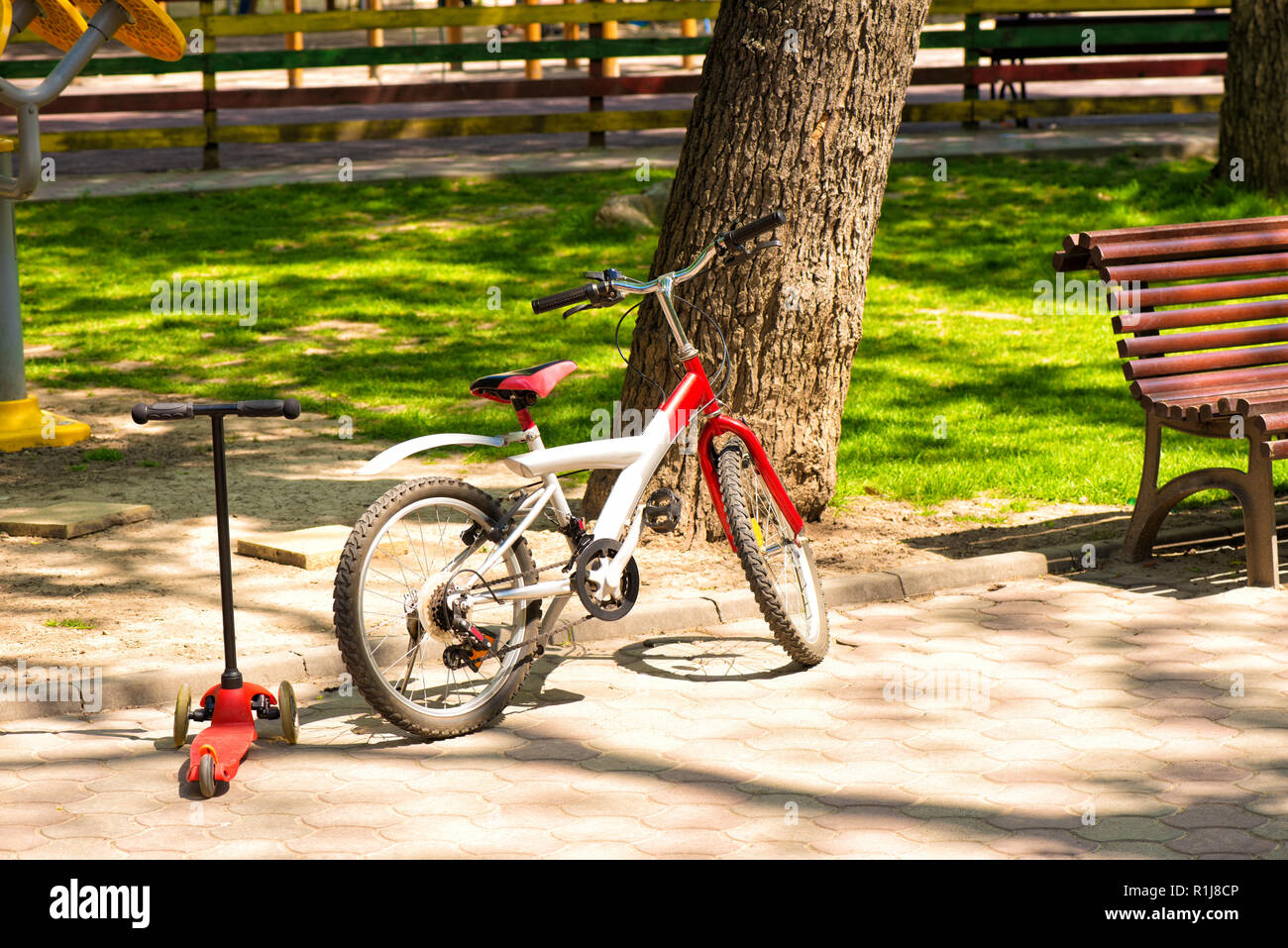 Bicycle and scooter for kids in the park Stock Photo