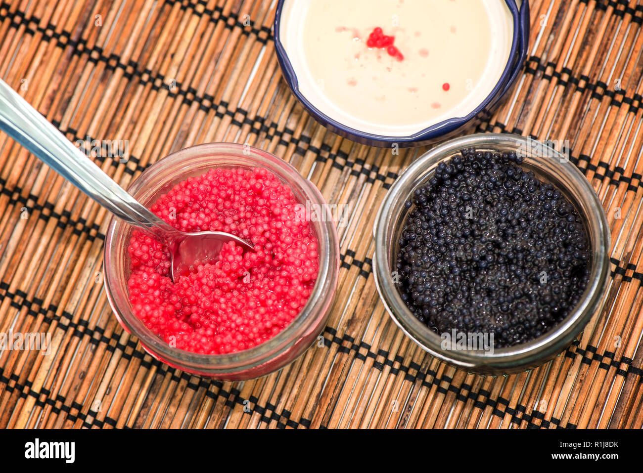 Two jars with lumpfish caviar red and black Stock Photo