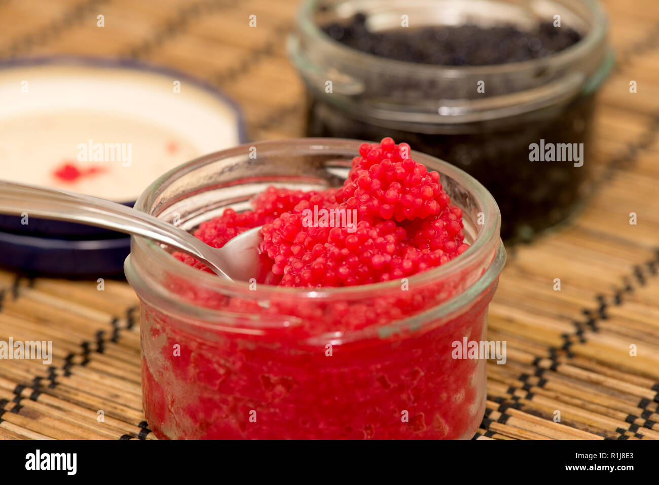 Detail with lumpfish caviar red and black in background Stock Photo