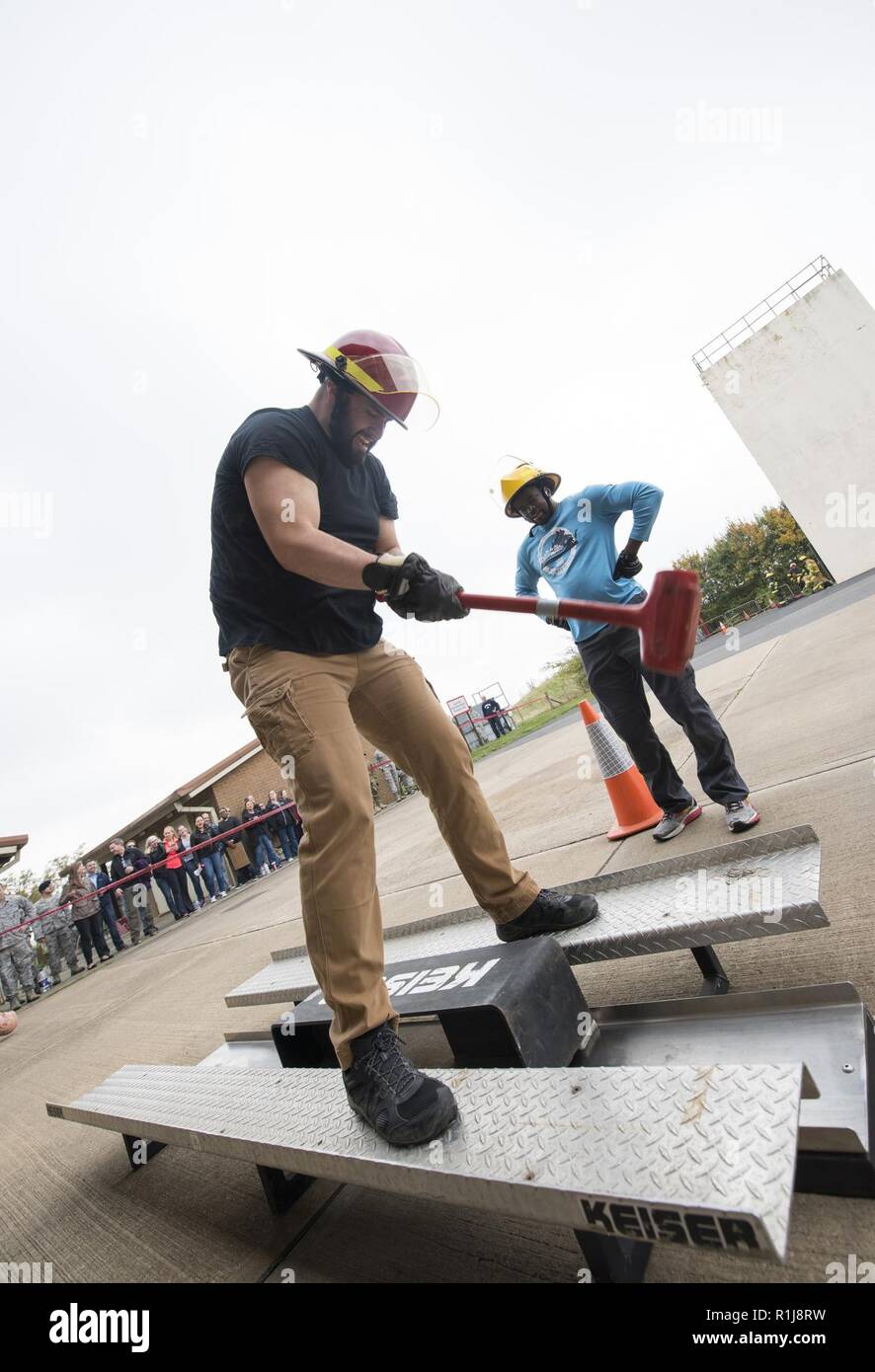 Mr. Raul Lopez hits a sledge hammer against a iron rail during a