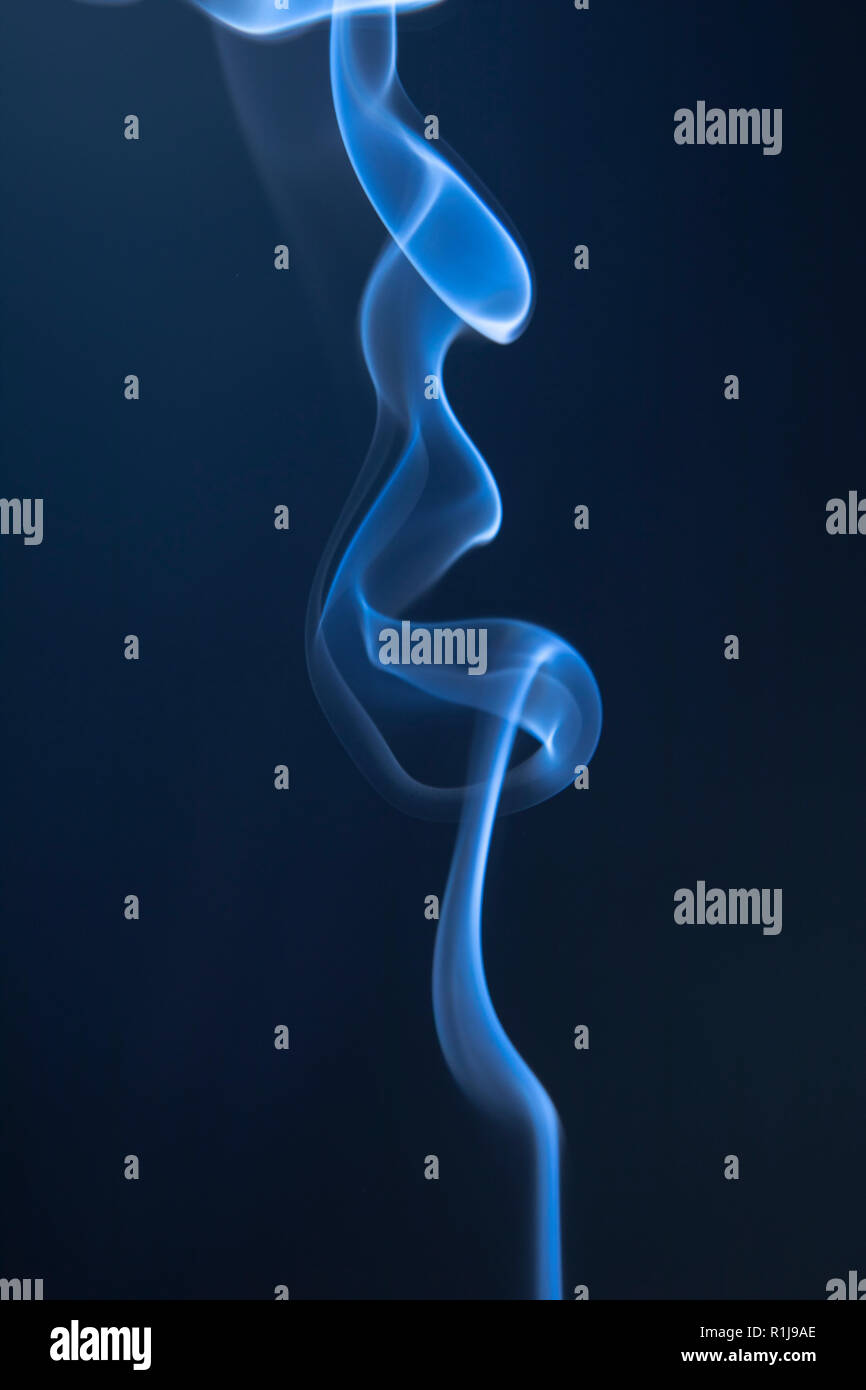 Abstract blue smoke swirls on dark background Stock Photo - Alamy